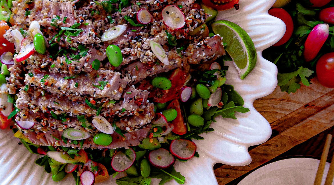 Asian-inspired sesame-crusted tuna with garlic ginger dressing and summer vegetables