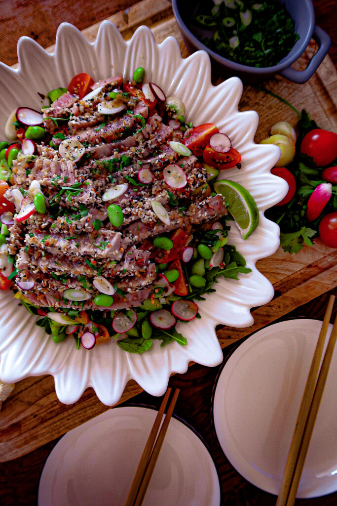 Asian sesame-crusted tuna with garlic ginger dressing and summer vegetable salad