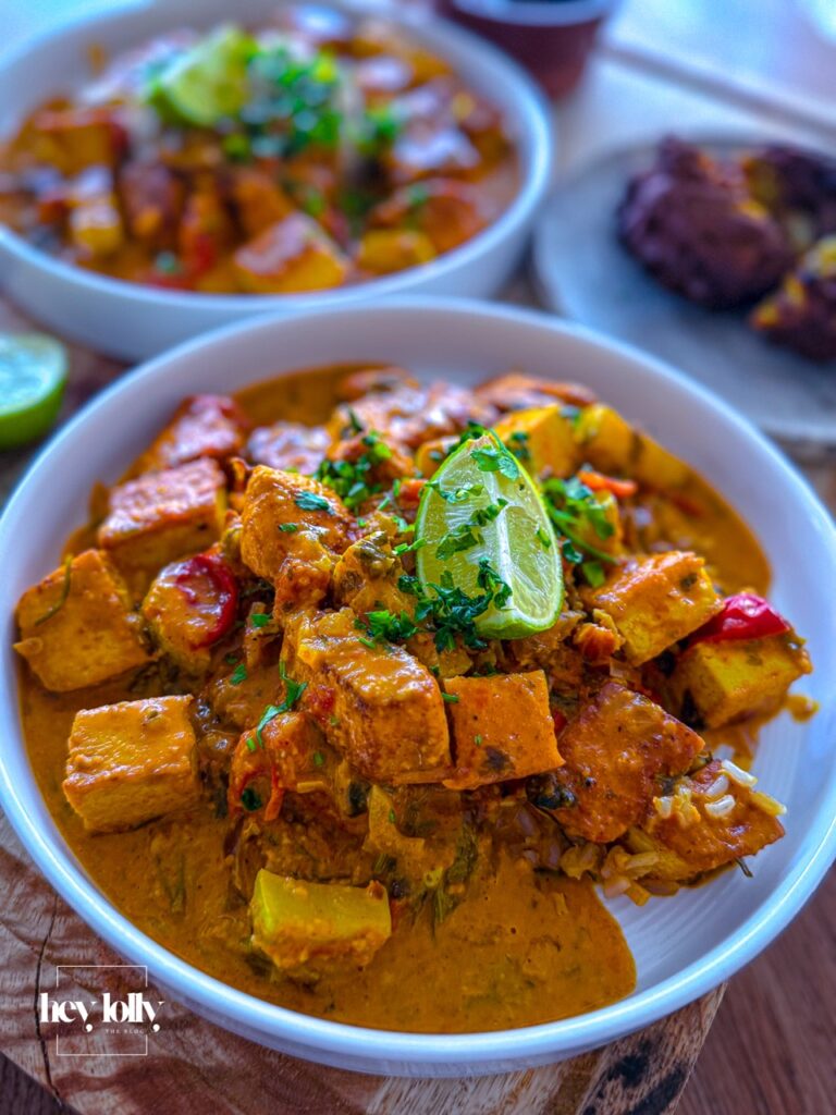 Bowl of creamy chicken and tofu tikka masala served with crispy onion bhajis and brown rice