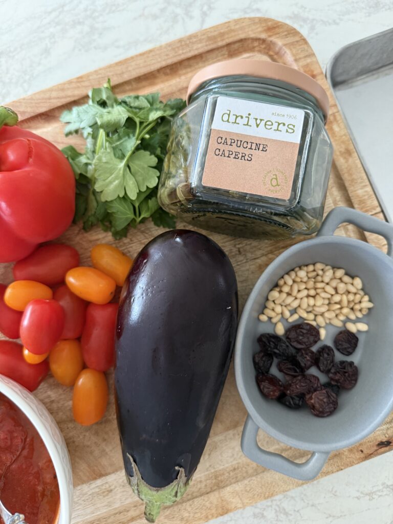 Ingredients for Sicilian sea bass with caponata including butterflied fish, aubergine, peppers, and Drivers Pickle caponata capers