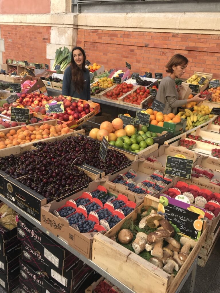 Fresh seasonal produce at a local market in Biarritz, illustrating how travel influences cooking by inspiring seasonal shopping habits.