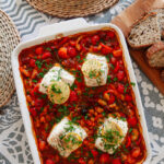 baked cod with chorizo served with crusty bread overhead