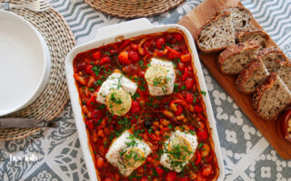 baked cod with chorizo served with crusty bread overhead