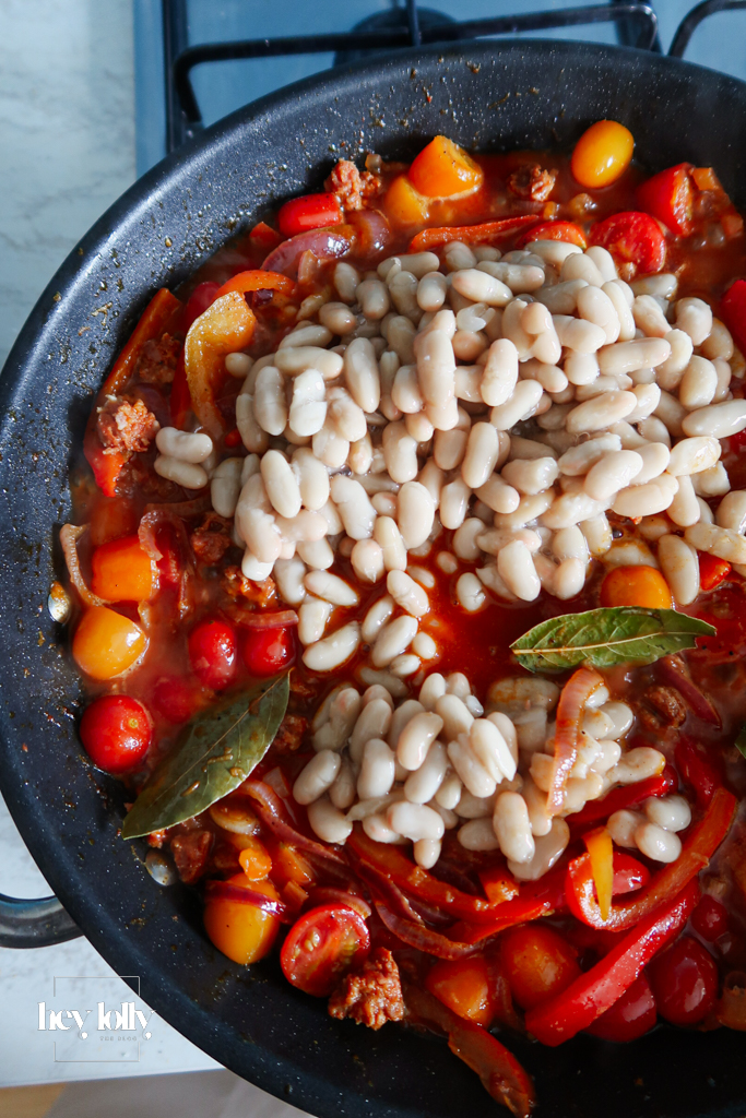 Veg base for baked cod with chorizo with tomatoes, peppers, onion and lemon.