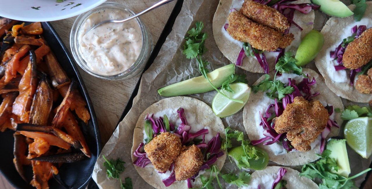 crispy cod tacos overhead shot with sweet potatoes chilli cream and slaw