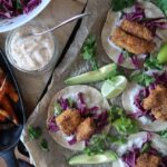 crispy cod tacos overhead shot with sweet potatoes chilli cream and slaw