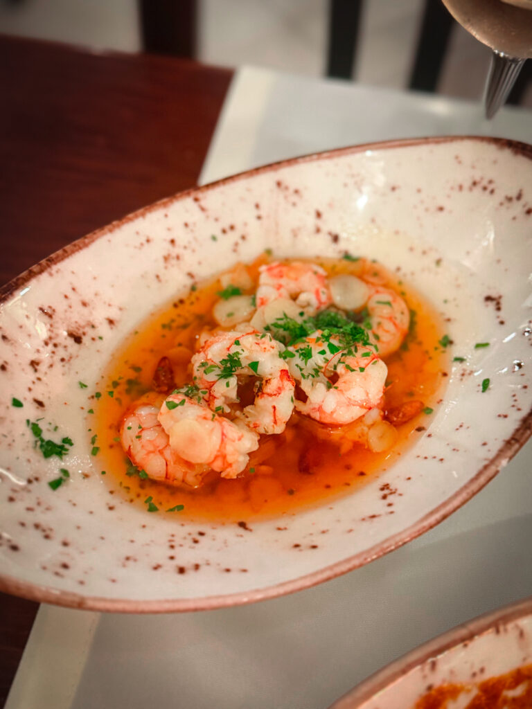 Spanish tapas plates shared at the table, showing how travel influences cooking by inspiring social dining rituals and the joy of lingering meals.