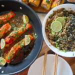 Glazed salmon fillet atop garlic-ginger quinoa pilaf with miso-glazed corn and fresh herbs.