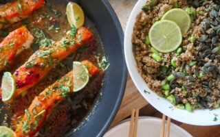 Glazed salmon fillet atop garlic-ginger quinoa pilaf with miso-glazed corn and fresh herbs.