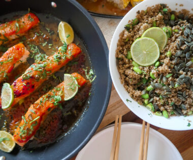 Glazed salmon fillet atop garlic-ginger quinoa pilaf with miso-glazed corn and fresh herbs.