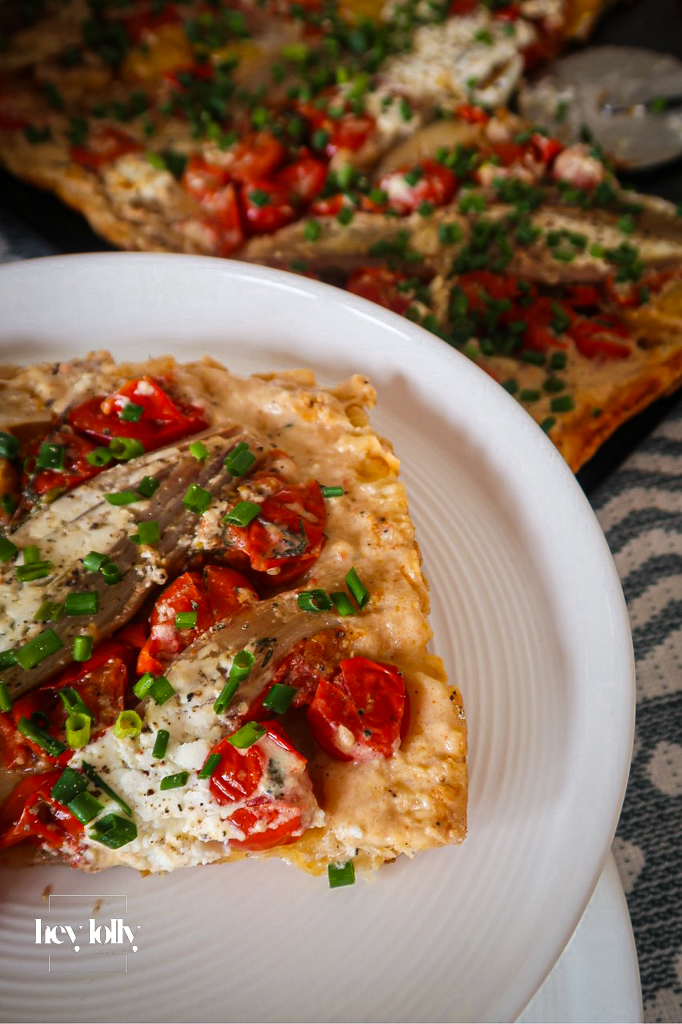 Close-up of caramelised shallot and tomato tart with puff pastry crust