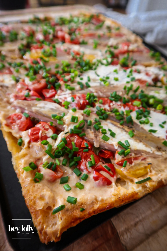 Overhead shot of a golden shallot and tomato tart fresh from the oven