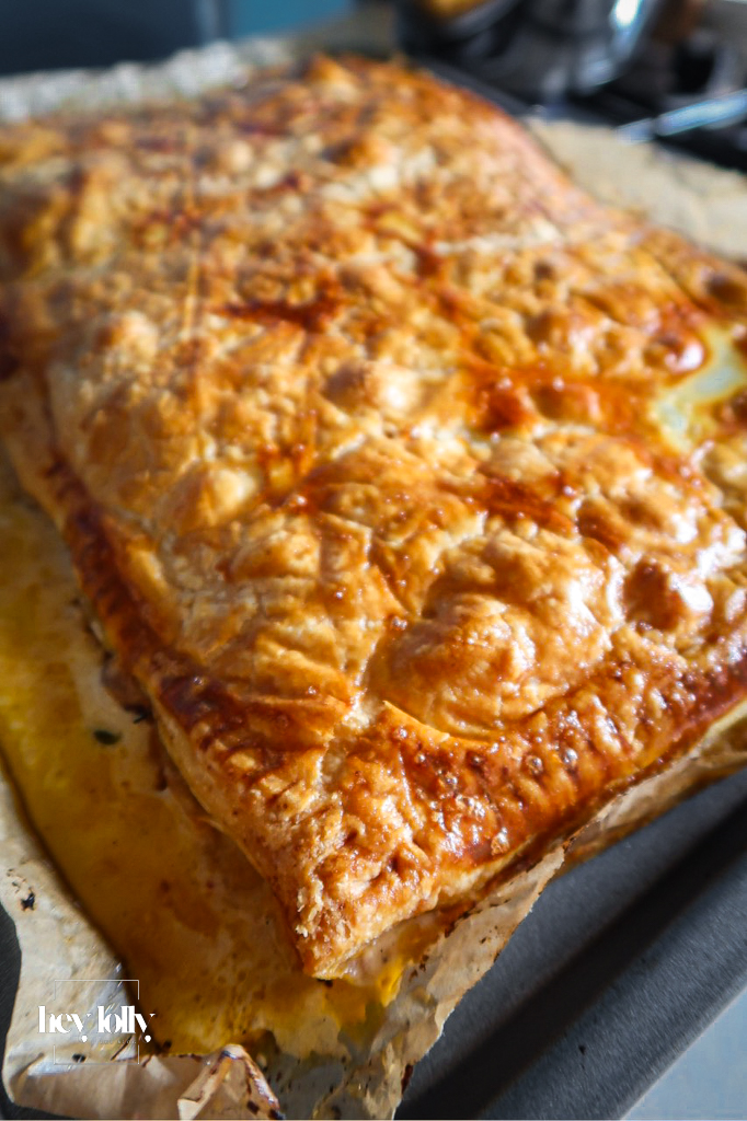 Overhead shot of a golden shallot and tomato tart fresh from the oven