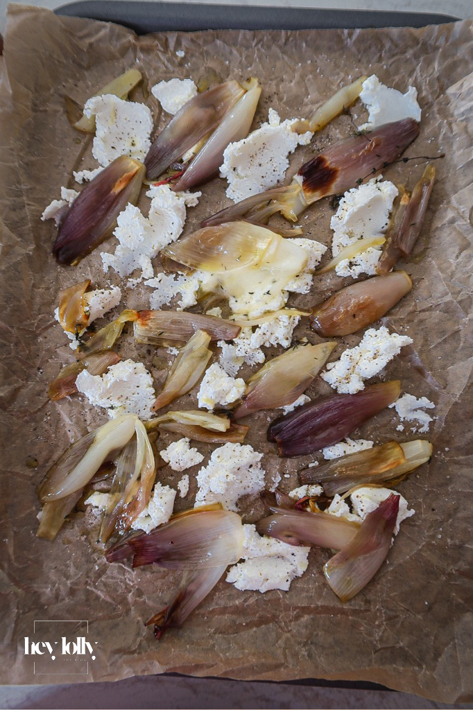 Caramelised shallots and cherry tomatoes in a pan for tart filling