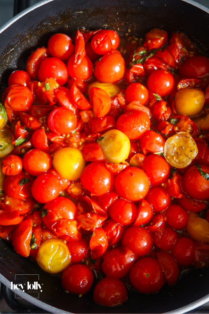 Caramelised shallots and cherry tomatoes in a pan for tart filling