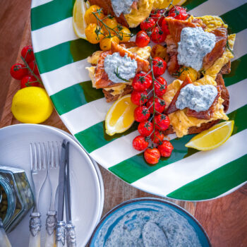 Scandi-style breakfast with eggs, mackerel, tomatoes, and crème fraîche on sourdough.