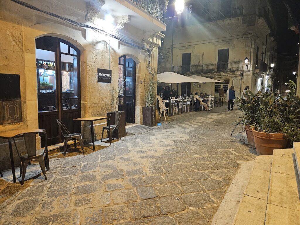 Outdoor tables at Anchovies Ortigia — where to eat in Ortigia with live music and local charm