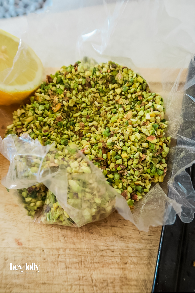Overhead kitchen scene with measured ingredients: grapefruit, cream, sugar, pistachios, flour, butter