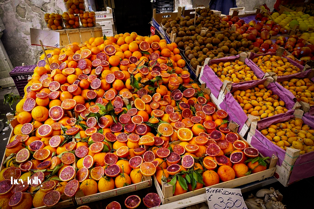 Fresh produce stalls at Ortigia’s daily open market with citrus and vegetables