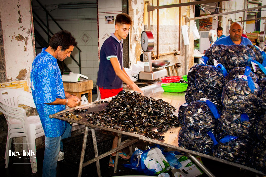Fresh produce stalls at Ortigia’s daily open market with seafood