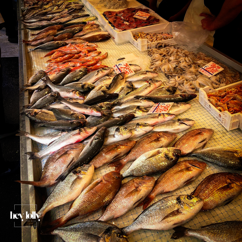 Fresh produce stalls at Ortigia’s daily open market with fish