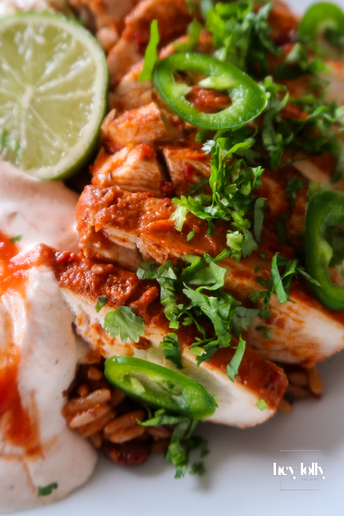 Spiced chicken strips sizzling in a hot frying pan with golden edges.
