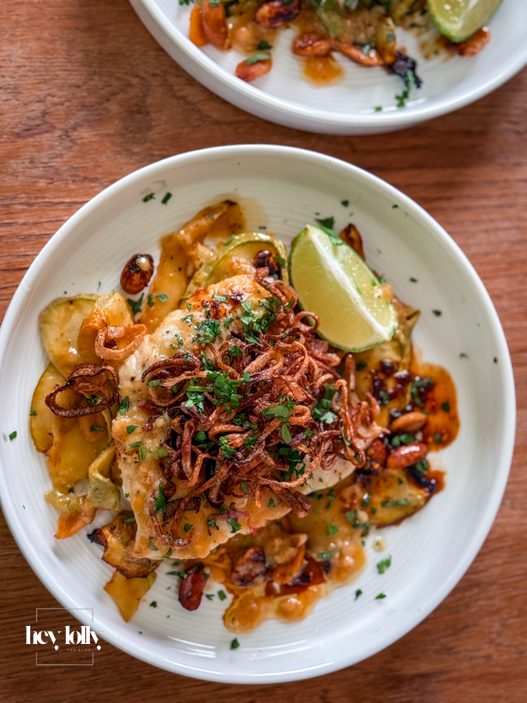 Plated miso butter cod with golden crispy shallots and fresh courgette noodles