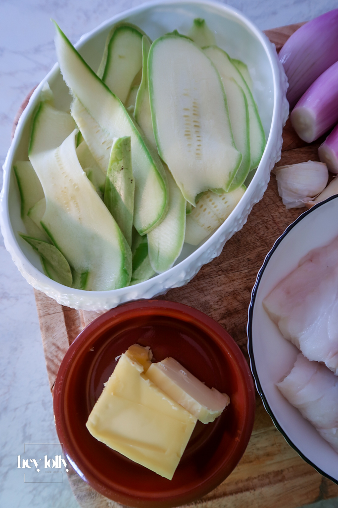 Raw cod fillets with miso butter ingredients on a board