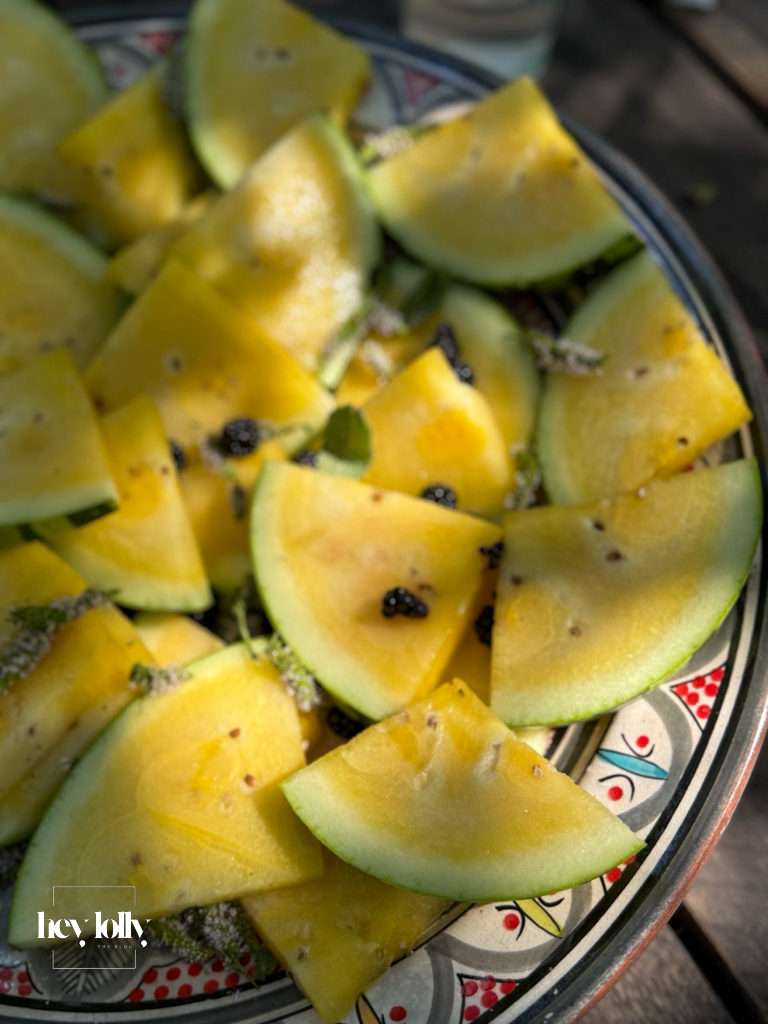 Refreshing slices of yellow watermelon with herbs, a seasonal dessert from the garden-to-table cooking class in Siracusa.