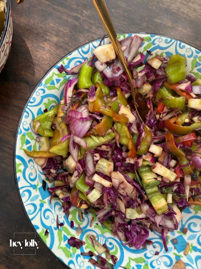 Fresh Sicilian salad of cabbage, peppers, and tomatoes in a patterned bowl at Slow Life Family Farm.