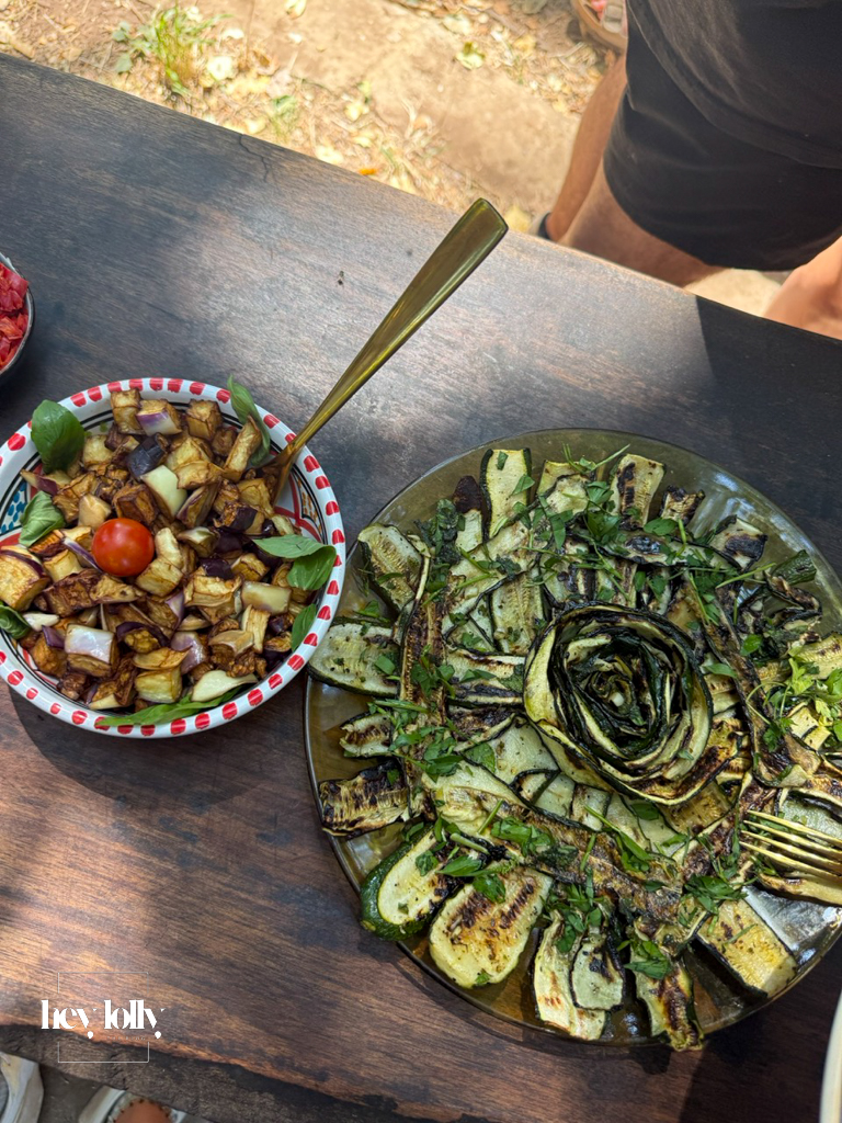 Plate of grilled courgette slices with fresh herbs, prepared at Slow Life Family Farm in Siracusa.