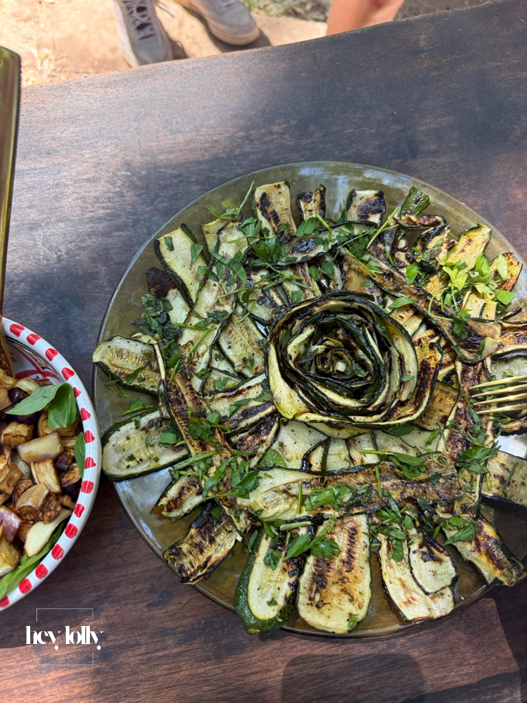 Plate of grilled courgette slices with fresh herbs, prepared at Slow Life Family Farm in Siracusa.