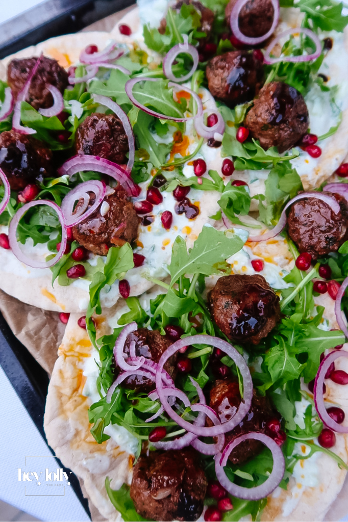 Harissa lamb meatballs glazed with pomegranate molasses on flatbread