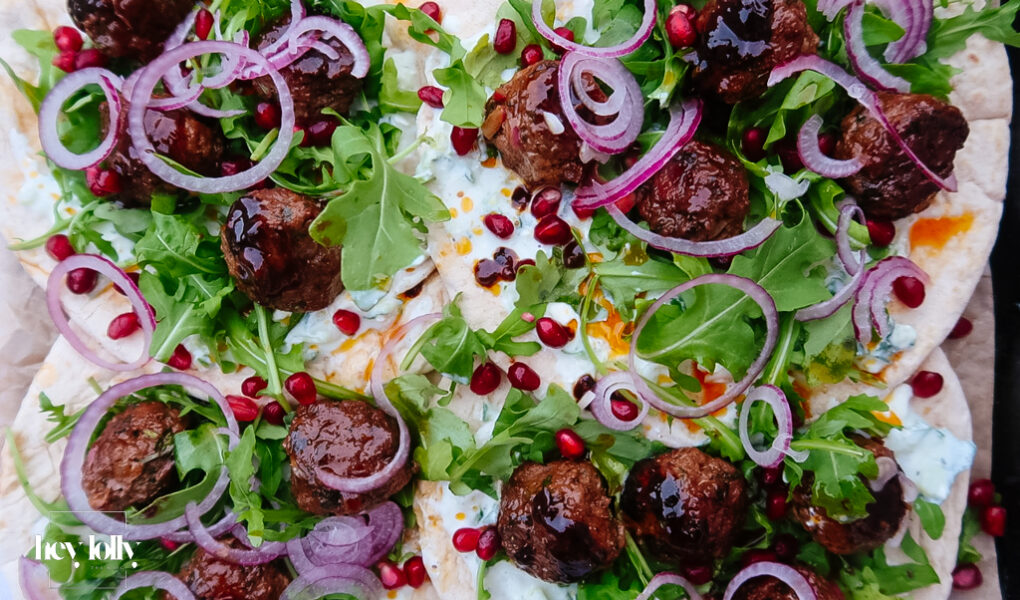 Harissa lamb meatballs glazed with pomegranate molasses on flatbread