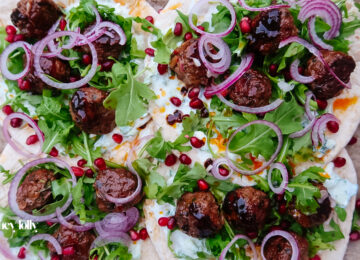 Harissa lamb meatballs glazed with pomegranate molasses on flatbread