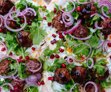 Harissa lamb meatballs glazed with pomegranate molasses on flatbread