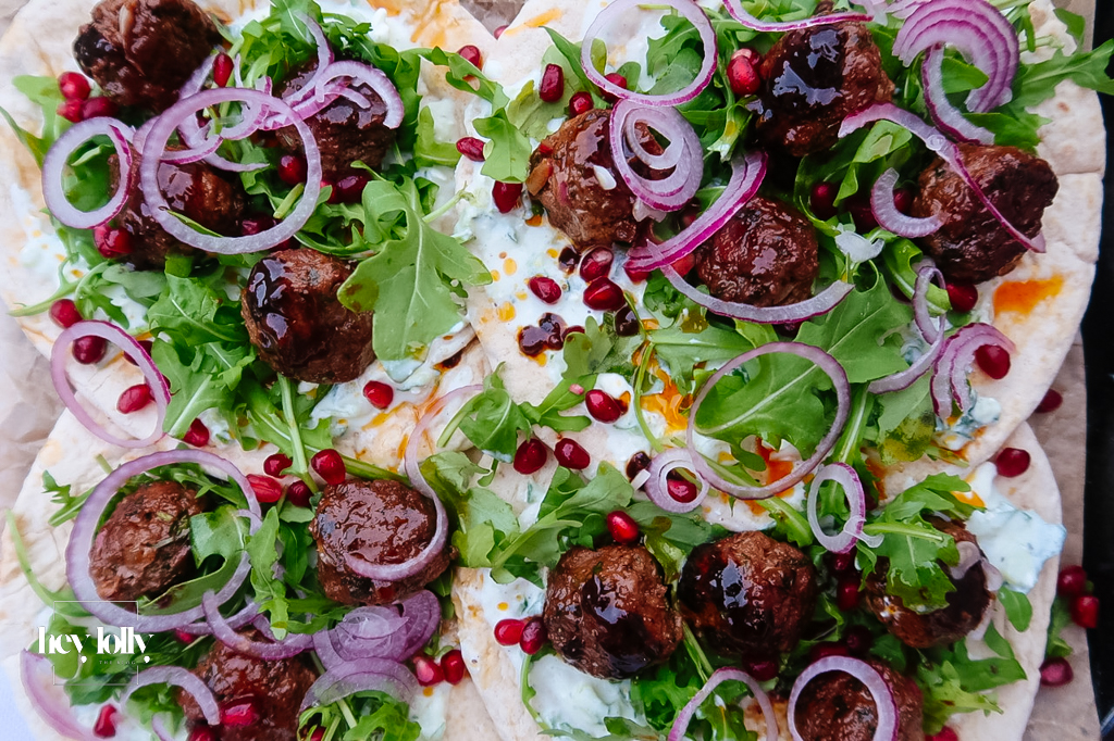 Harissa lamb meatballs glazed with pomegranate molasses on flatbread