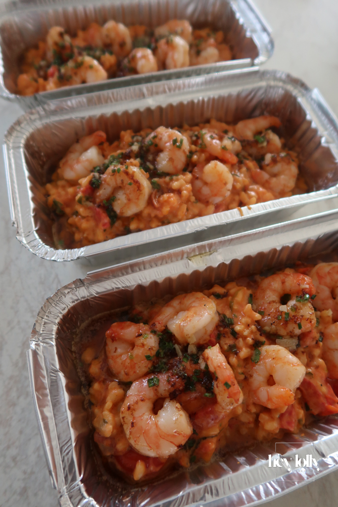 Portioned king prawn tomato risotto in foil containers, ready for meal prep
