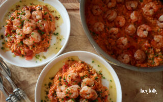 Creamy king prawn tomato risotto served with garlic lemon butter and chives