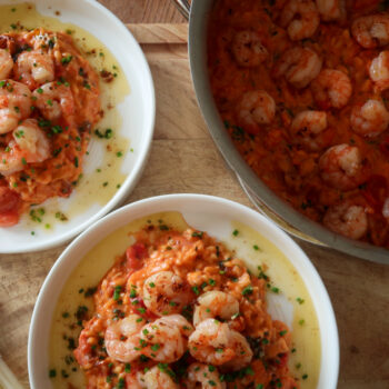 Creamy king prawn tomato risotto served with garlic lemon butter and chives