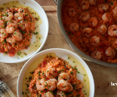 Creamy king prawn tomato risotto served with garlic lemon butter and chives