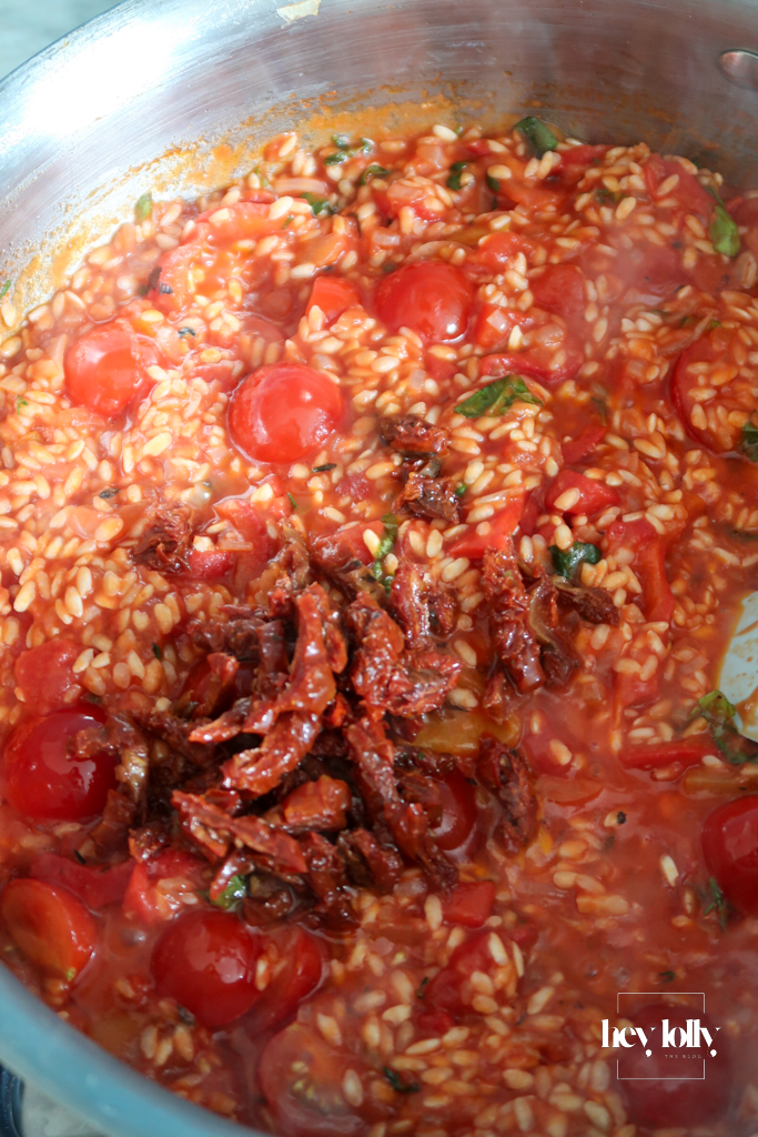Tinned and fresh tomatoes simmering into risotto rice for king prawn tomato risotto