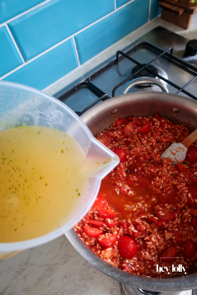 Tinned and fresh tomatoes simmering into risotto rice for king prawn tomato risotto waiting for stock to be added