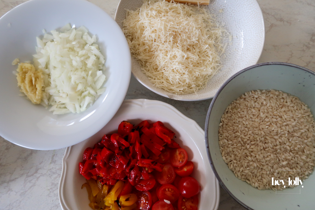Fresh ingredients for king prawn tomato risotto including prawns, arborio rice, cherry tomatoes, and Parmesan