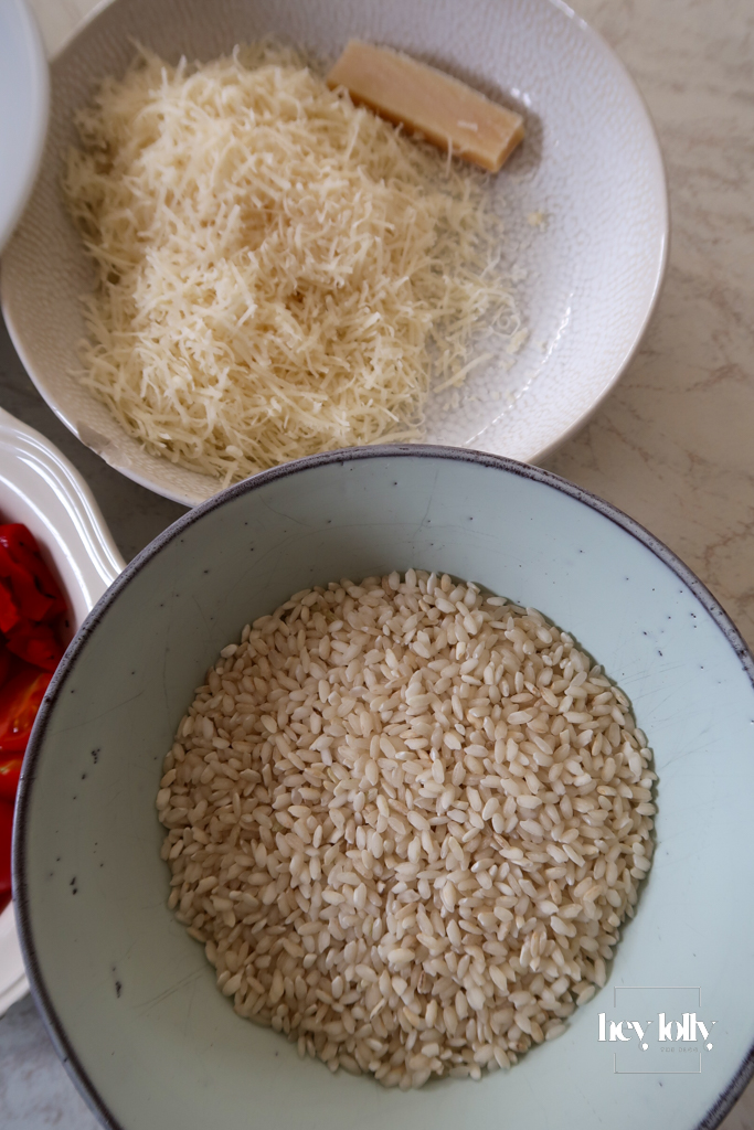 Fresh ingredients for king prawn tomato risotto including arborio rice and Parmesan
