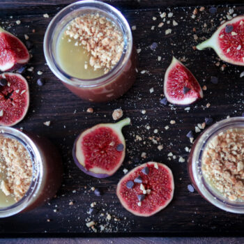Salted Caramel Chocolate Pots served in small glasses, topped with glossy caramel and sea salt flakes.
