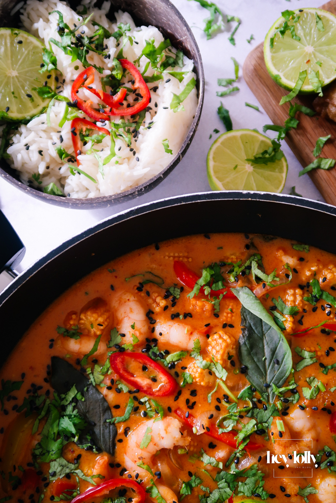 Close-up of Thai Red King Prawn curry showing prawns in creamy coconut-red sauce.
