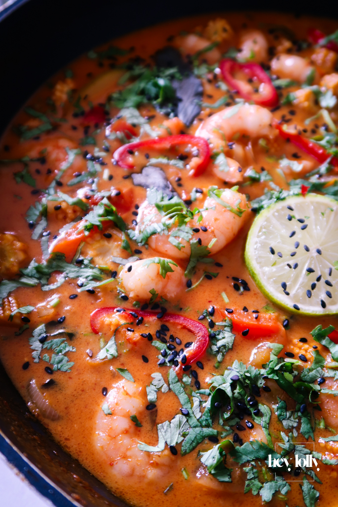 Finished Thai Red King Prawn curry served with jasmine rice and fresh coriander garnish.