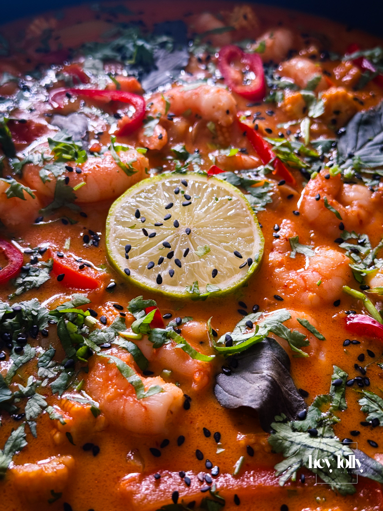 Finished Thai Red King Prawn curry served with jasmine rice and fresh coriander garnish.