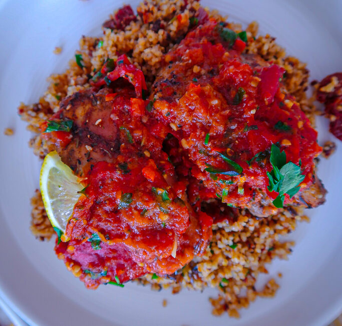 Za’atar Chicken Thighs served with couscous and roasted tomato anchovy sauce